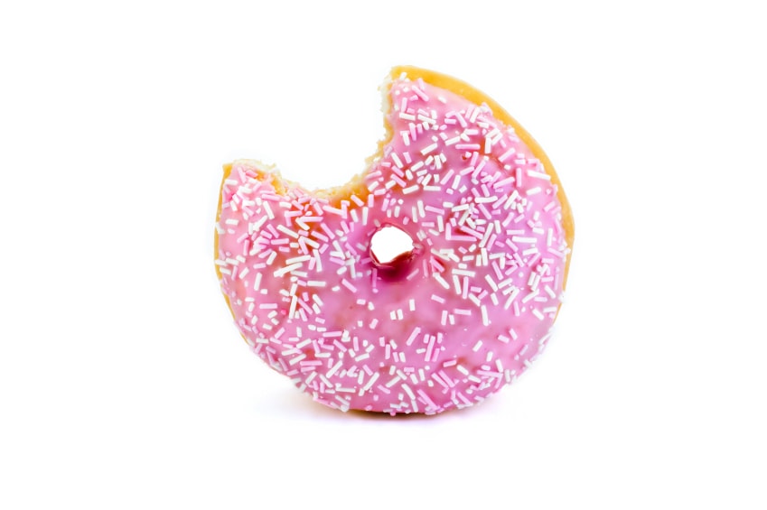 strawberry flavoured doughnut witha bite taken out isolated on white